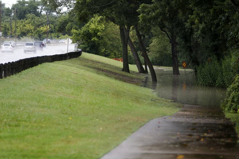 Water flooded White Rock Creek Trail along Abrams Road in Dallas on Saturday.