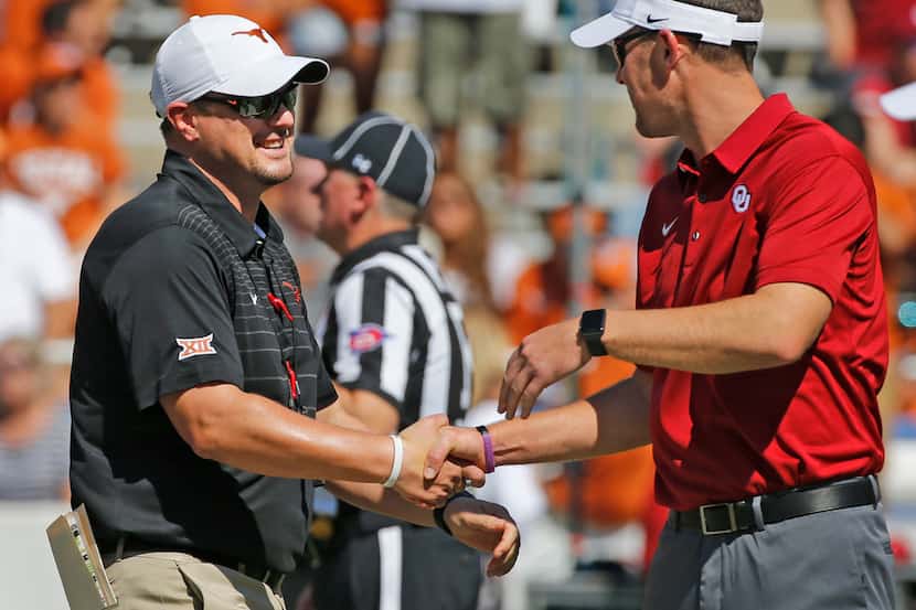 FILE - Texas head coach Tom Herman and Oklahoma head coach Lincoln Riley shake hands before...
