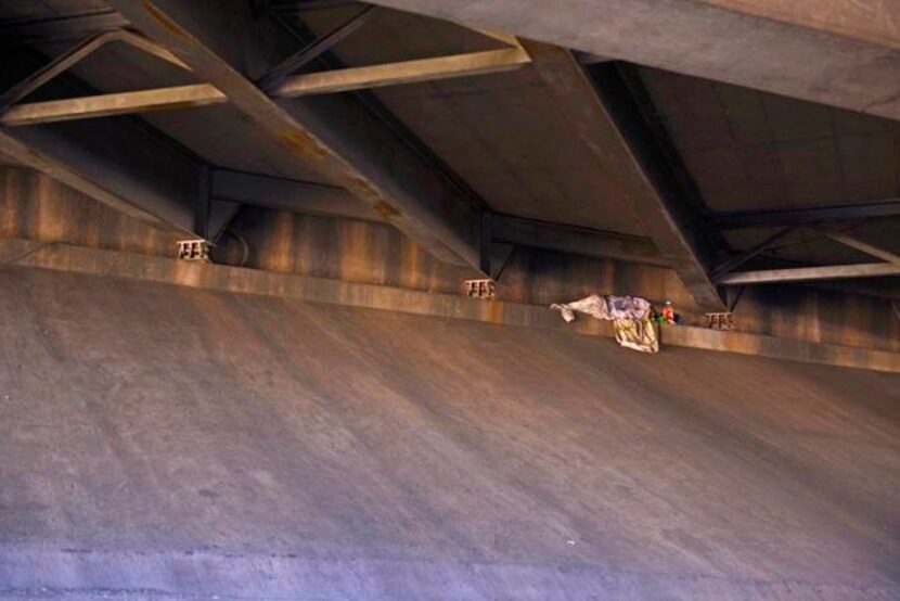 
A homeless person lies under an Interstate 635 bridge along Jupiter Road in Garland.
