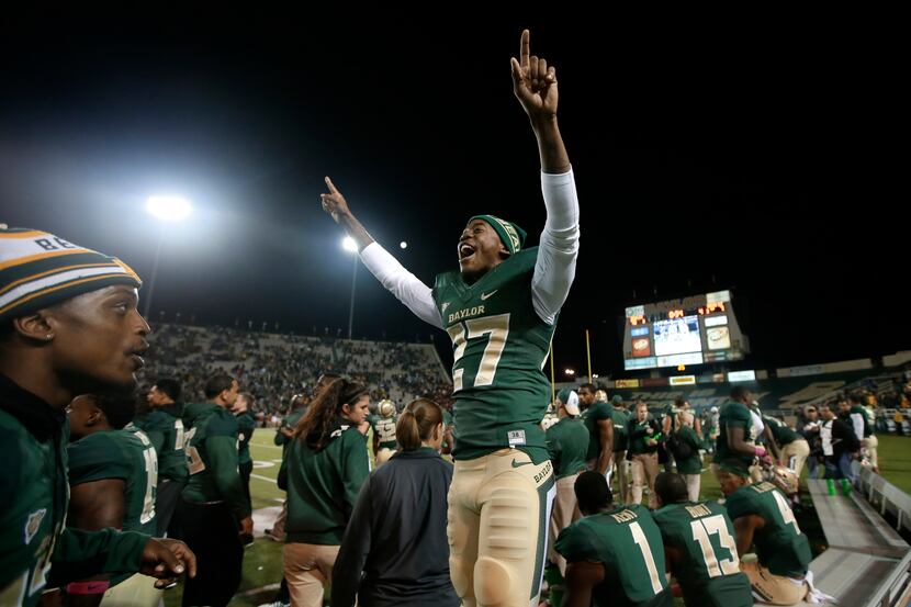 Baylor cornerback Tyler Stephenson (27)  celebrates on the team bench in the final seconds...