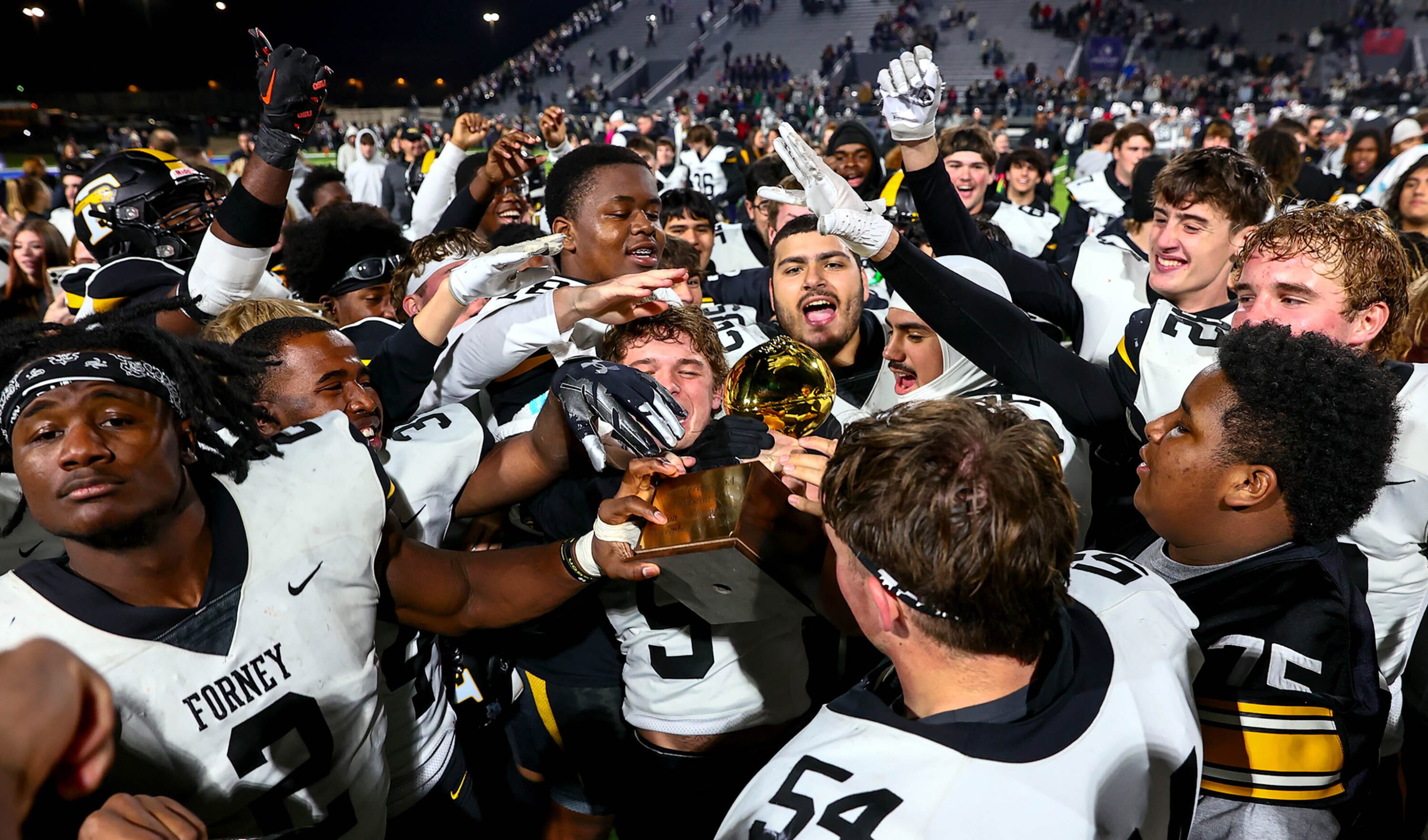 The Forney Jackrabbits celebrate with their trophy, as they beat Richland, 61-40 in the...