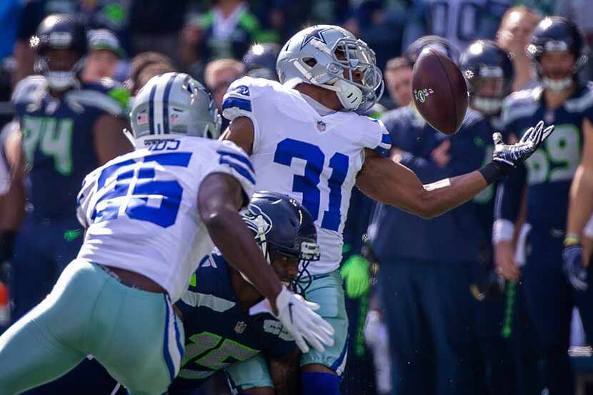 FILE - Cowboys cornerback Byron Jones (31) nearly intercepts a pass intended for Seattle...