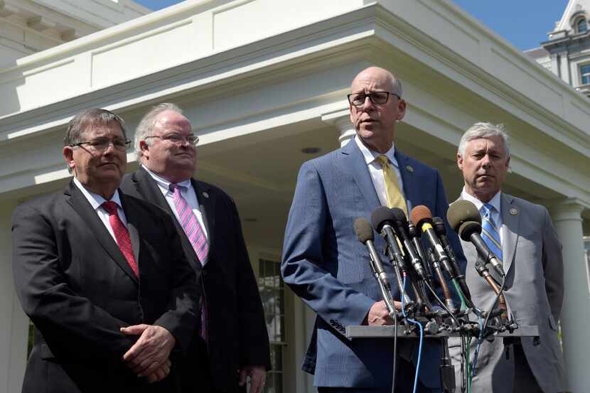 Rep. Greg Walden (second from right) speaks to reporters outside the White House in...