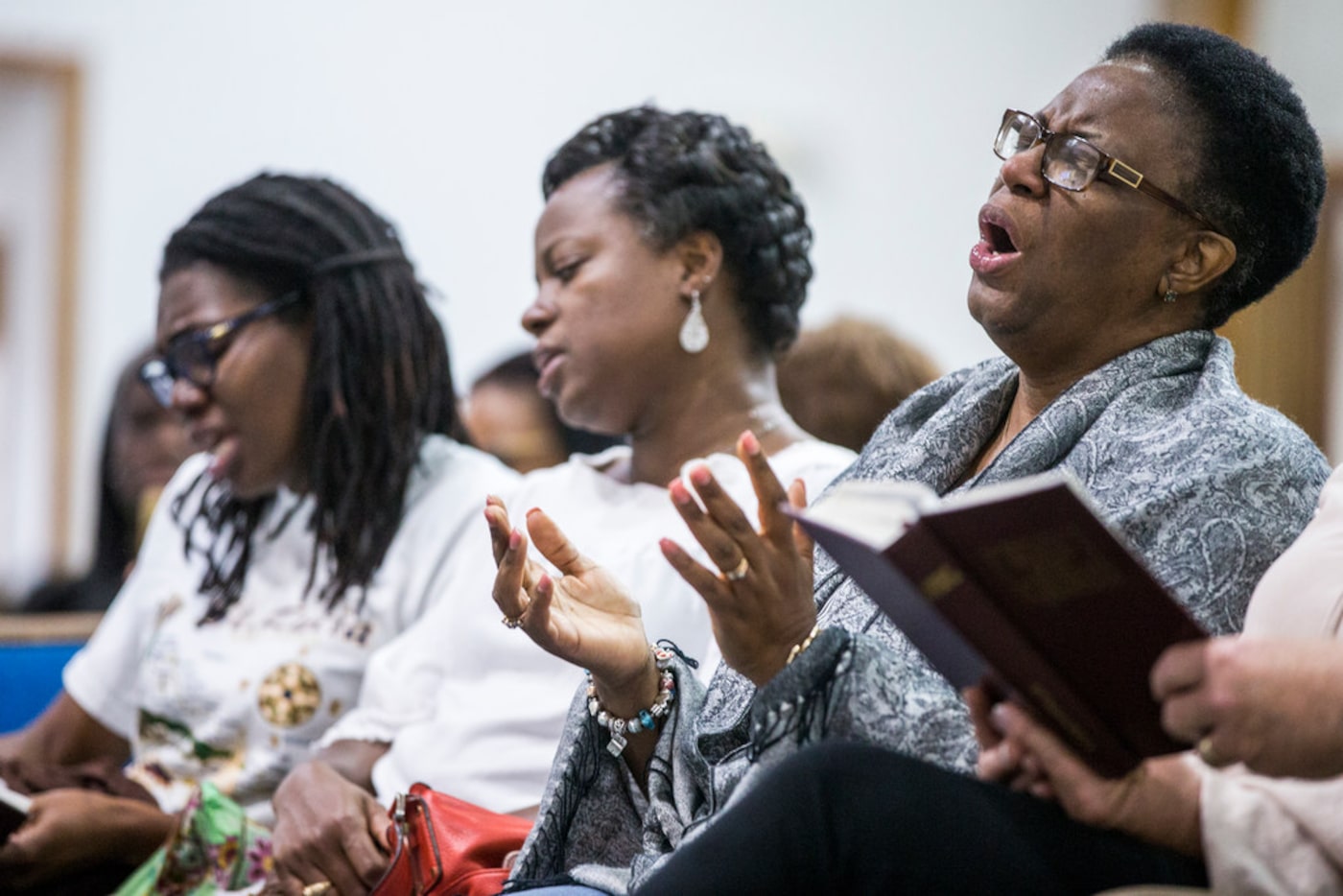 Allison Jean, mother of Botham Shem Jean, sings during a prayer vigil for her son at the...