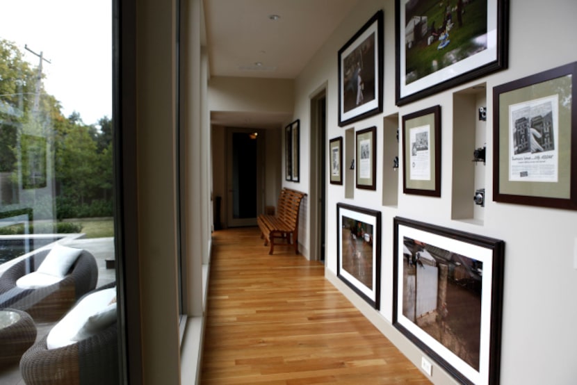 A hallway with photographer Jeremy Lock's photographs and cameras at the home of D'Andra...