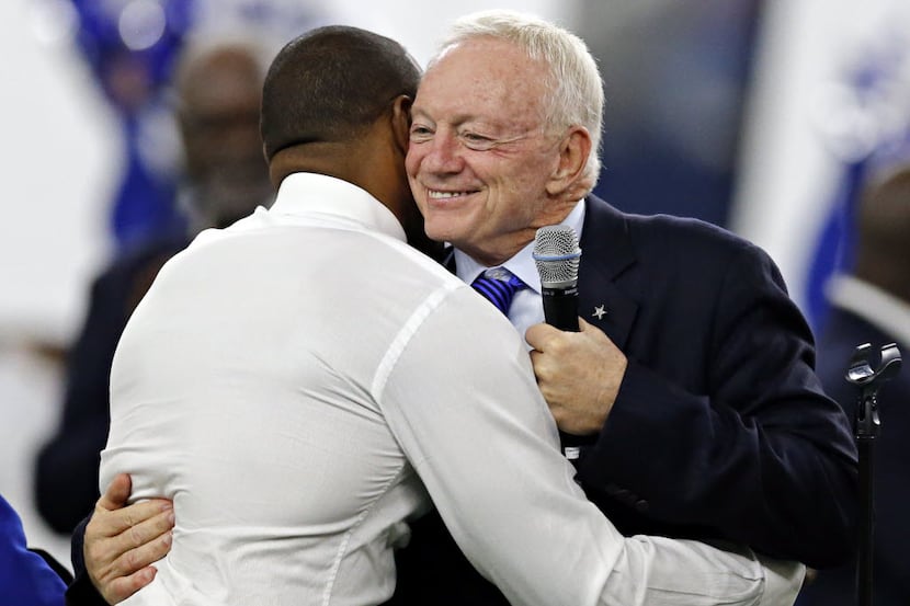 Dallas Cowboys owner Jerry Jones (right) hugs Darren Woodson as he is inducted into the Ring...