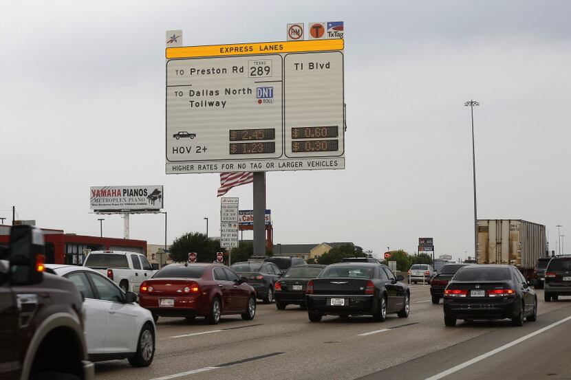 A new sign posts the cost for toll-lane users on the westbound lanes of LBJ Freeway near...