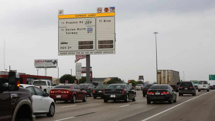  A new sign posts the cost for toll-lane users on the westbound lanes of LBJ Freeway near...