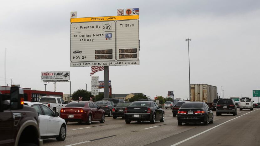  A new sign posts the cost for toll-lane users on the westbound lanes of LBJ Freeway near...