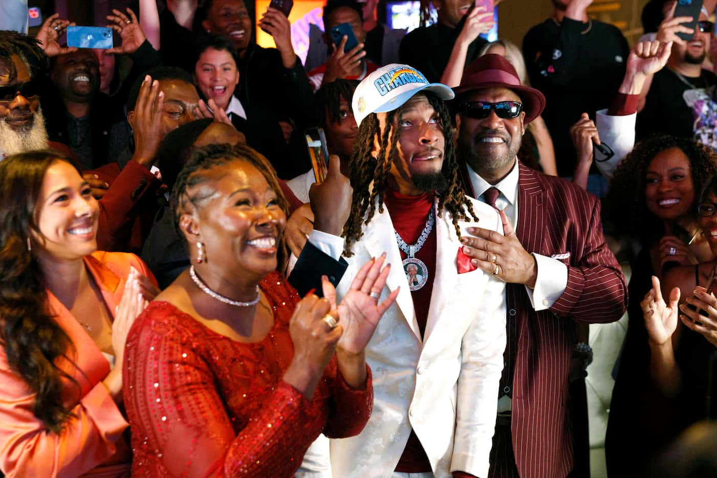 TCU wide receiver Quentin Johnston (center) reacts alongside his mother Sherry Johnston...