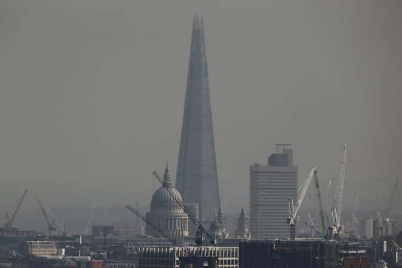 
The Shard rises above St. Paul’s Cathedral in this April photo. The building was designed...