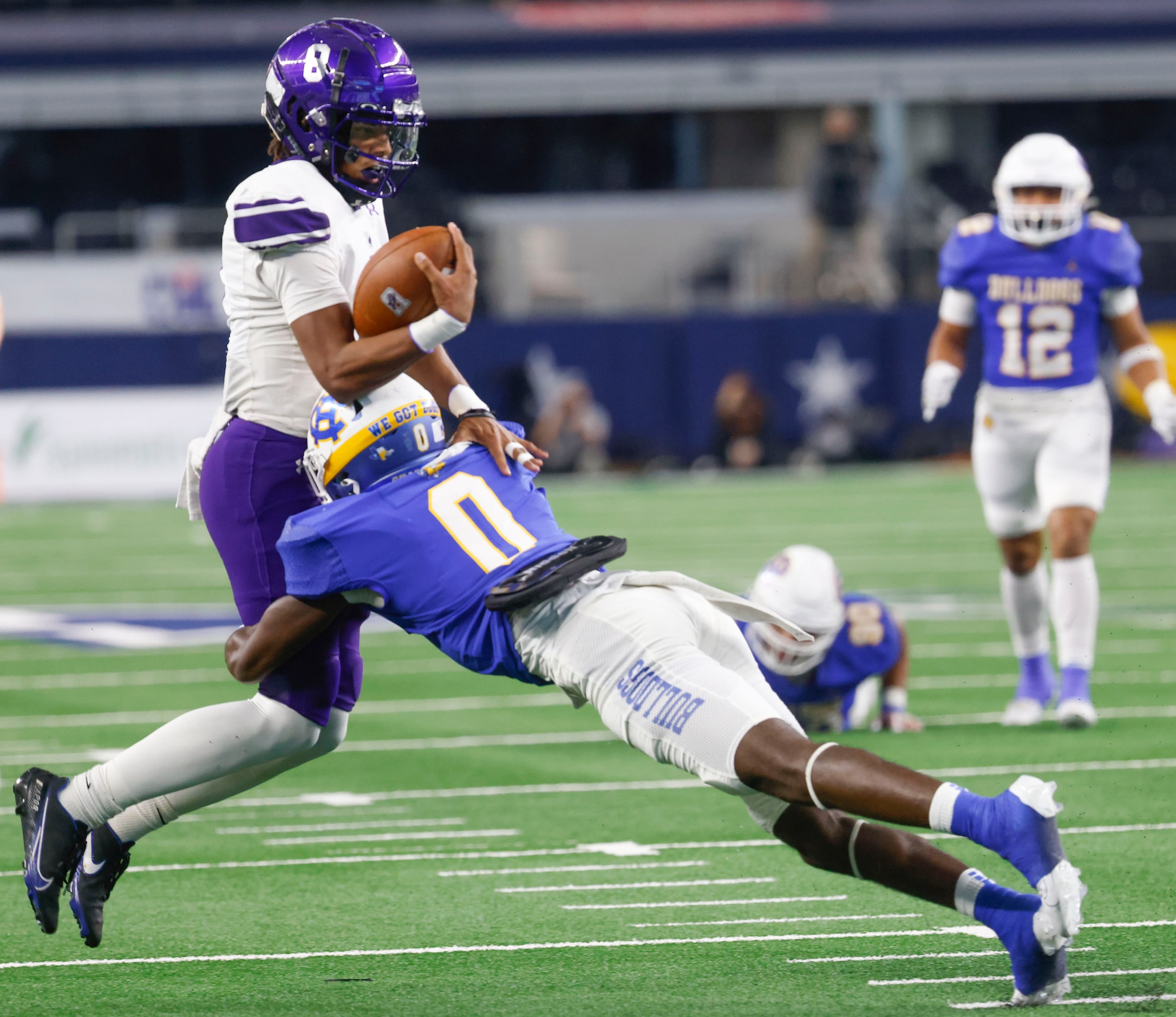 Anna High’s Ziondre Williams (left) gets tackled by Tyler Chapel Hill’s Jayvin Mayfield...