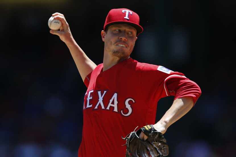 Texas Rangers starting pitcher Lucas Harrell delivers to the Kansas City Royals during the...