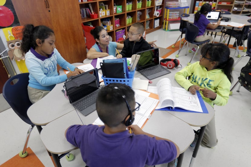 Mission Ridge Elementary School third-grade bilingual teacher Blanca Garda works with her...