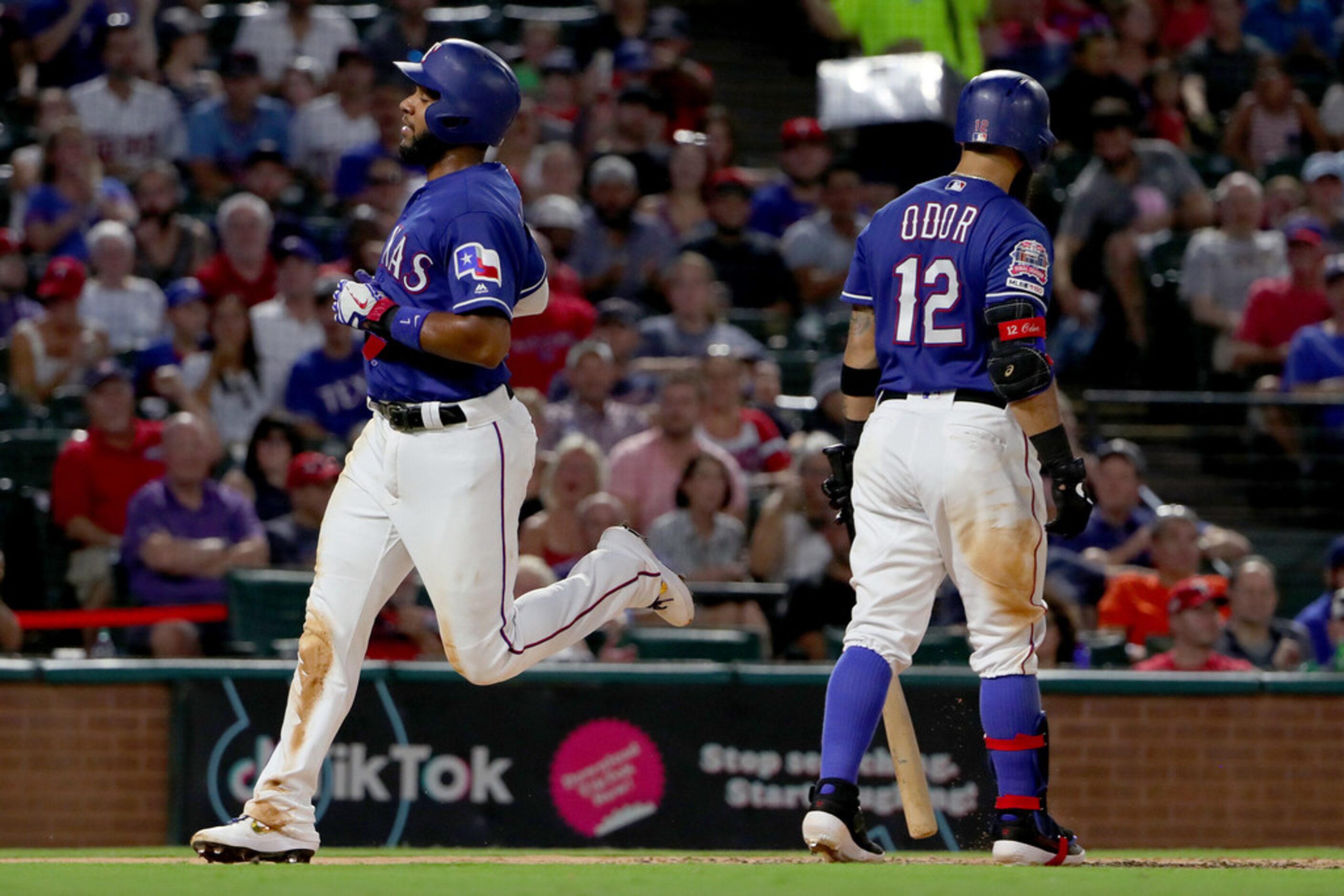 ARLINGTON, TEXAS - AUGUST 16: Elvis Andrus #1 of the Texas Rangers scores on a wild pitch...