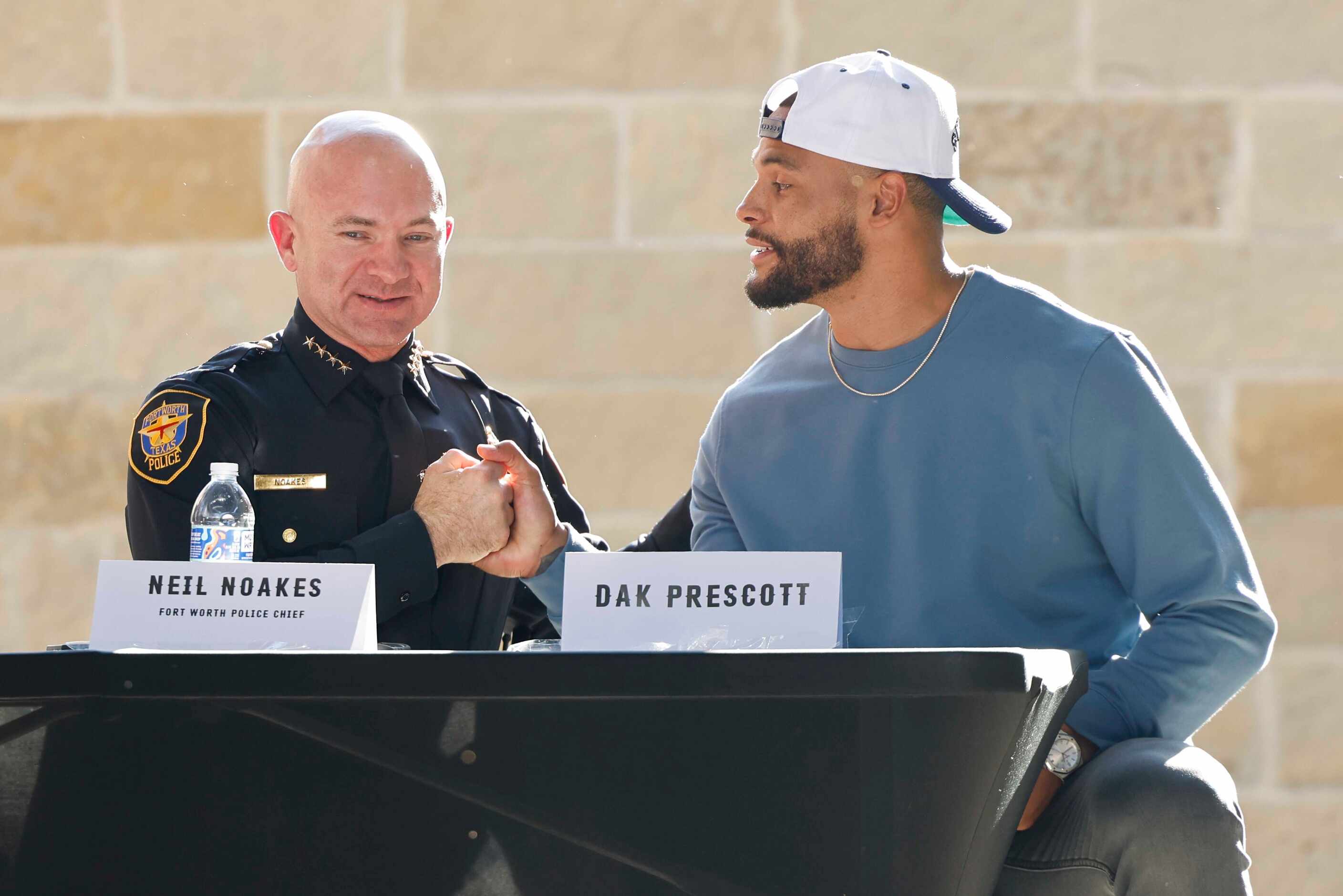 Fort Worth Police Chief Chief Noakes, left, shakes hand with founder of Faith Fight Finish...