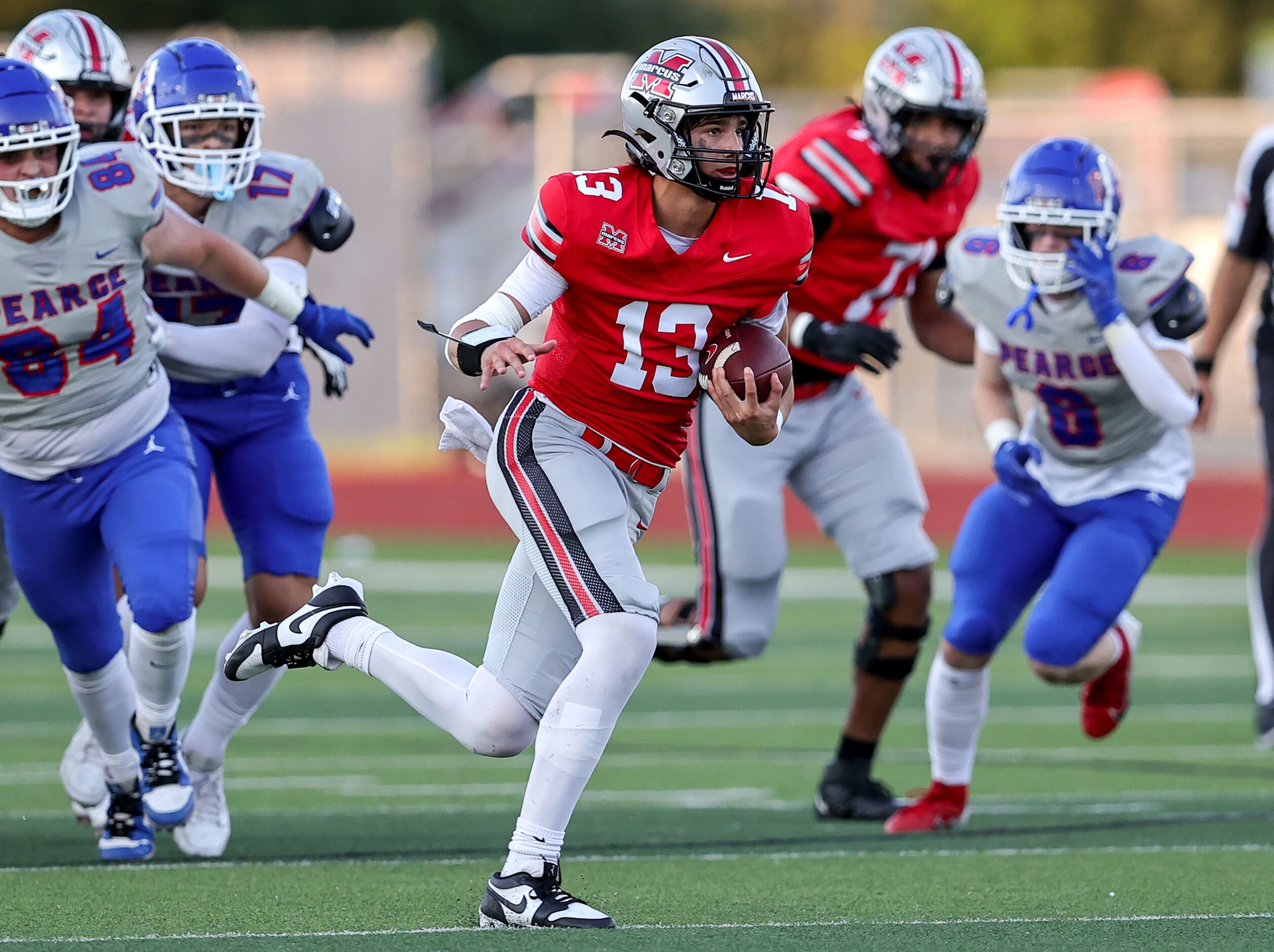 Flower Mound Marcus quarterback Colton Nussmeier (13) scrambles for a first down against...