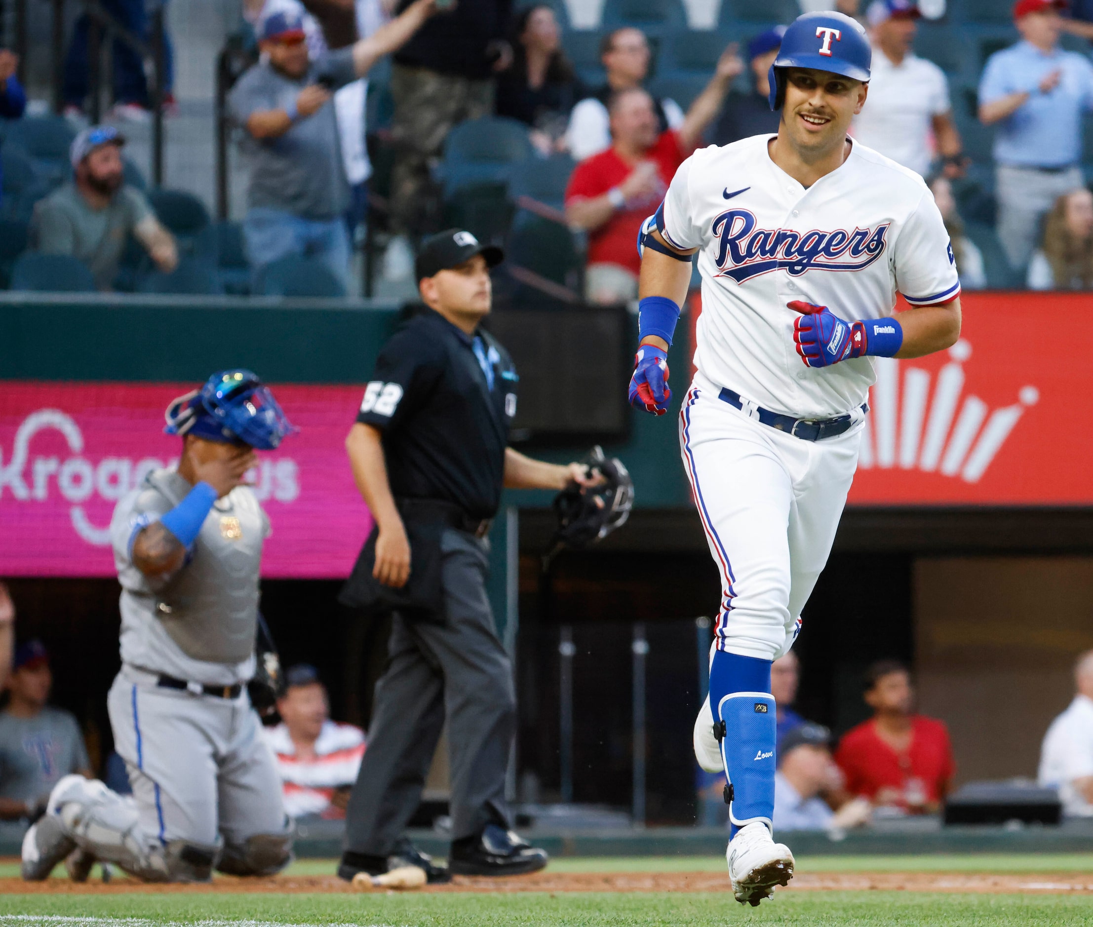 Texas Rangers first baseman Nathaniel Lowe reacts after hitting a home run on a fly ball...