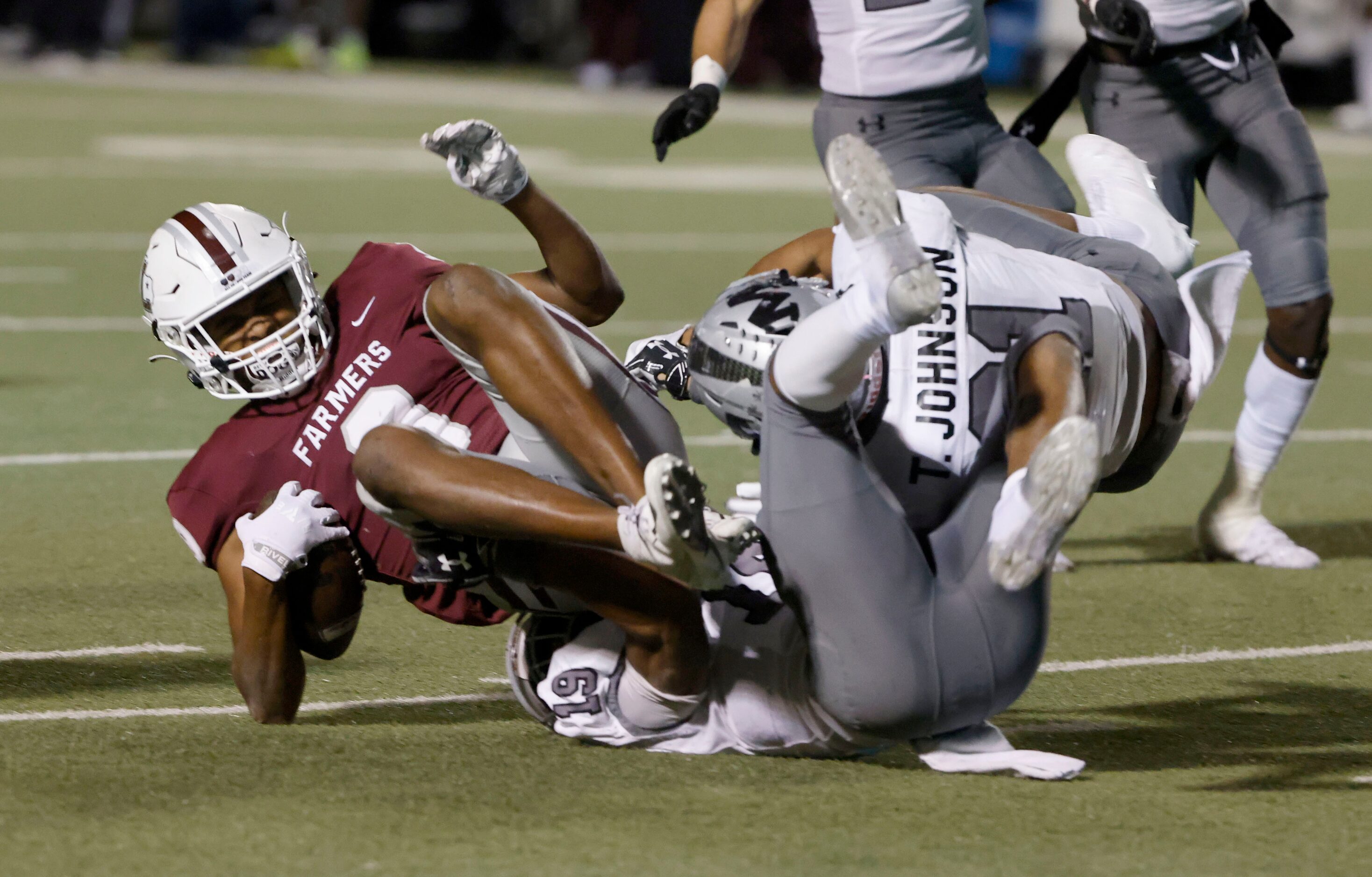 Lewisville’s Armani Winfield (9) is tackled by Arlington Martin’s Placide Djungu-Sungu (19)...