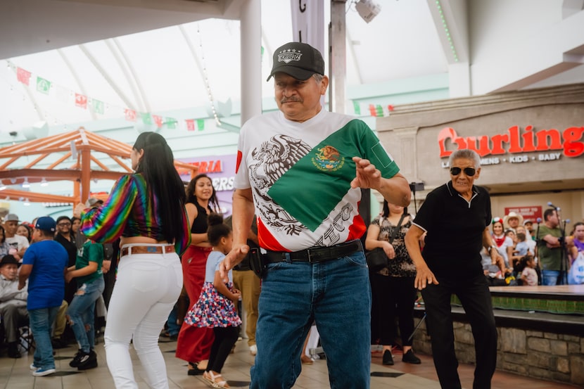 Spectators dance as Los Komberz performs for Las Fiestas Patrias at La Gran Plaza de Fort...