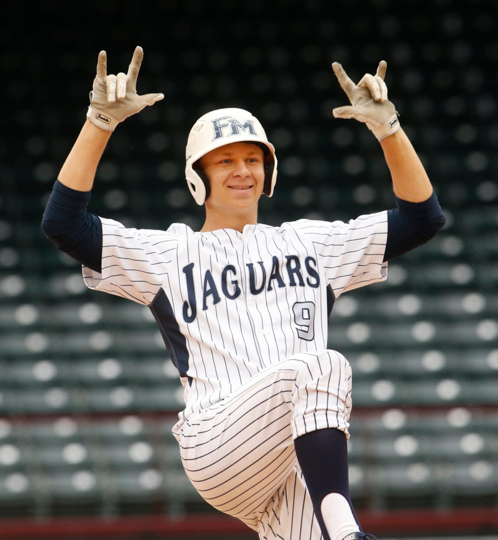 Flower Mound designated hitter Geoff Marlow (9) gestures toward the team dugout after...