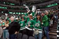 Dallas Stars fans celebrate a goal by left wing Mason Marchment during the third period of...