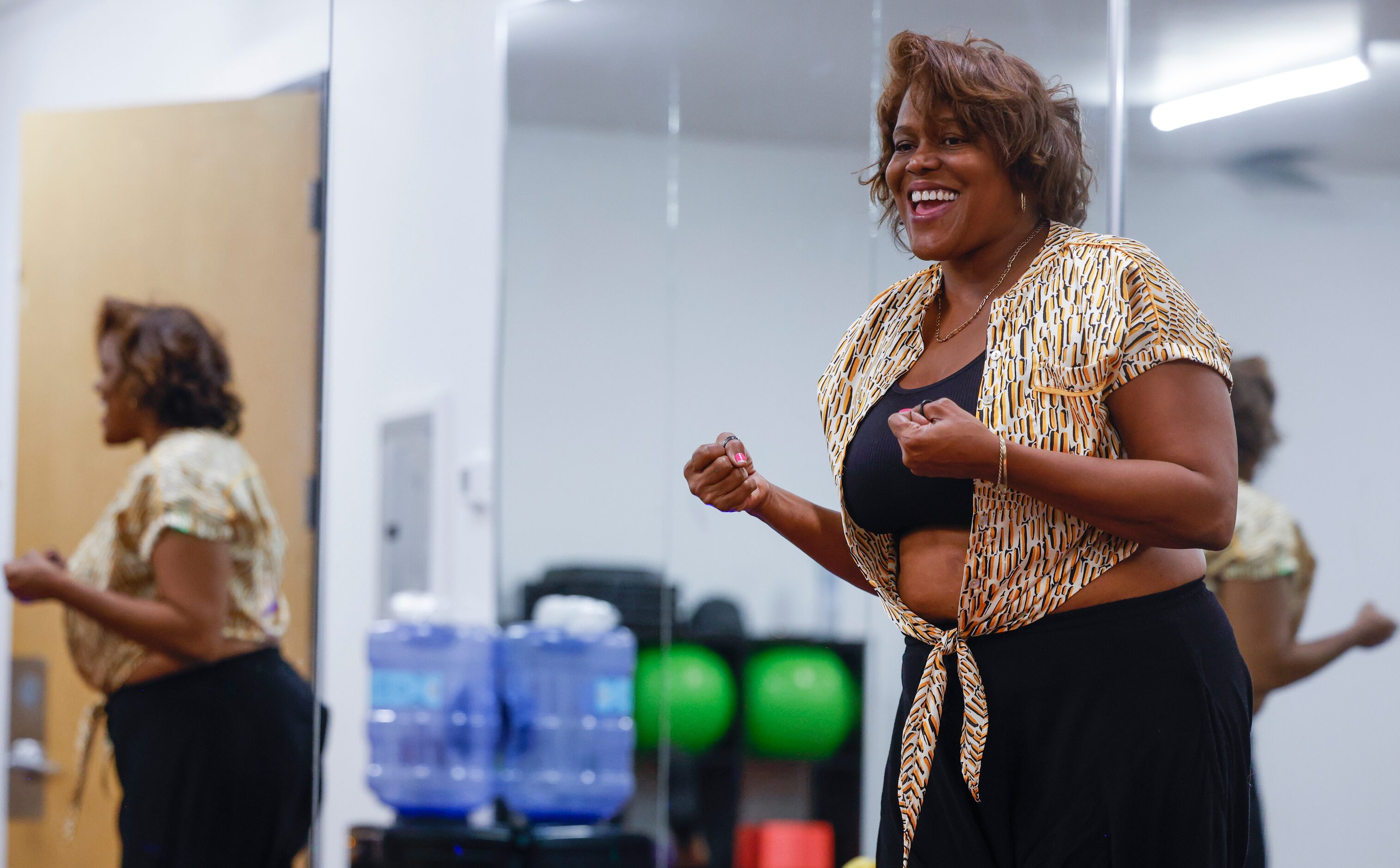 Instructor Cassandra Young, cheers to energize the group during a yoga session at Abounding...