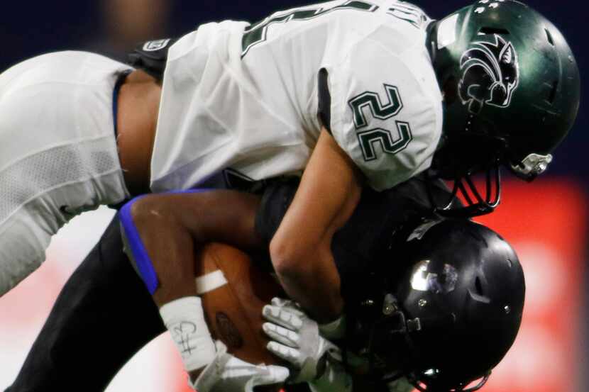 Kennedale's JD Coffey (22) tackles Kaufman running back Jay Gasper (3) after a short ground...