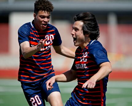 Wakeland midfielder Micah Kelley (20) runs to celebrate with Brennan Bezdek (22) after...