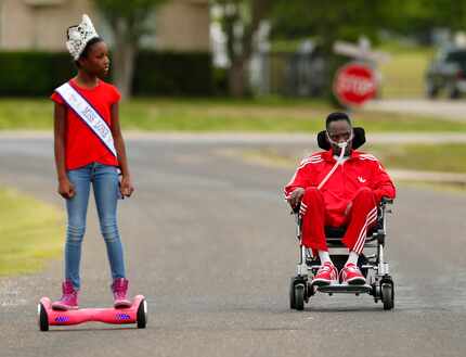 He in his wheelchair, she on her hoverboard - Alana Dixon and her father Rickey Dixon take a...