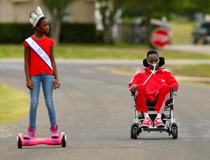 He in his wheelchair, she on her hoverboard - Alana Dixon and her father Rickey Dixon take a...