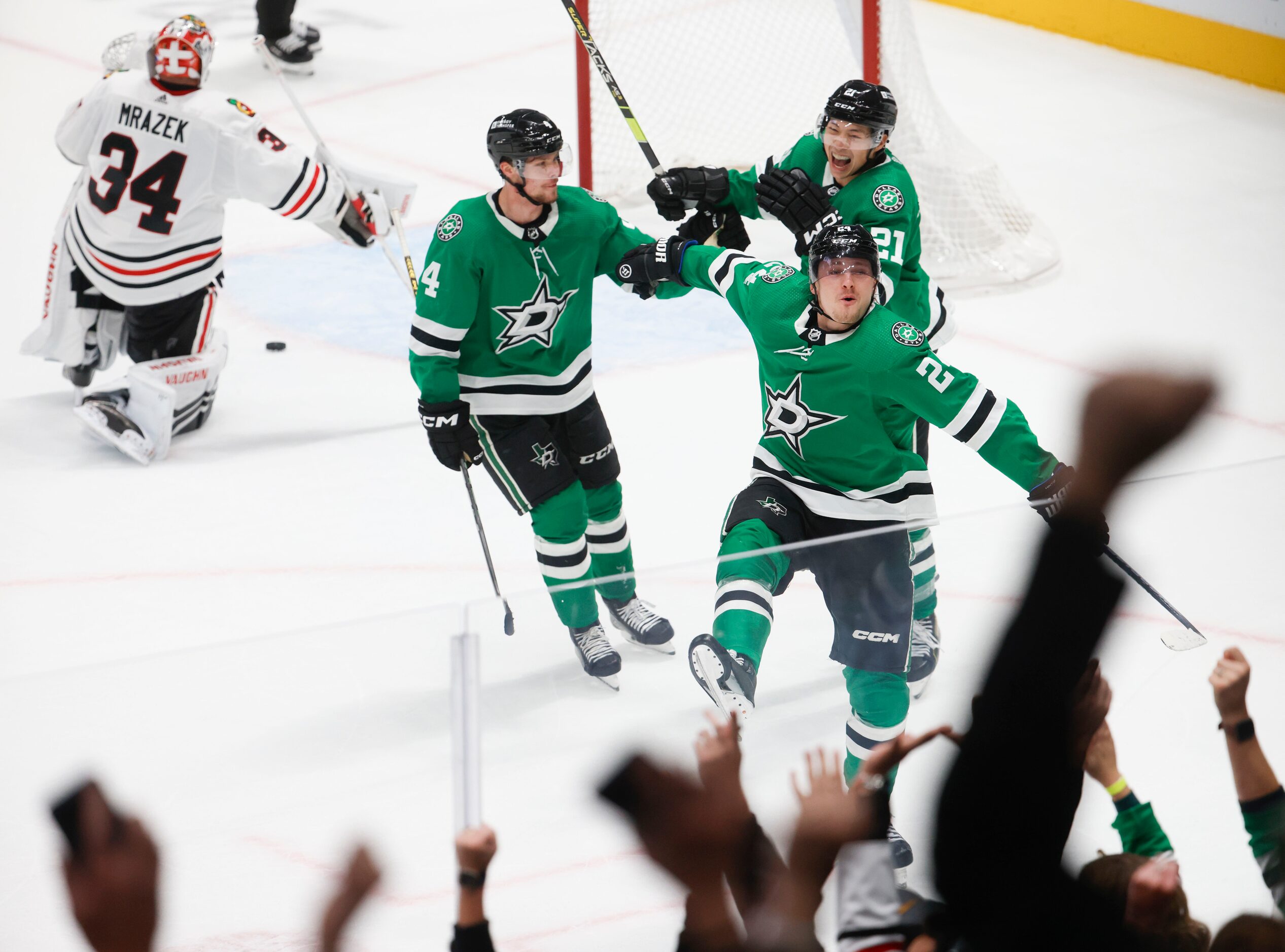 Crowd cheers as Dallas Stars center Roope Hintz (center) celebrates with Miro Heiskanen (4)...