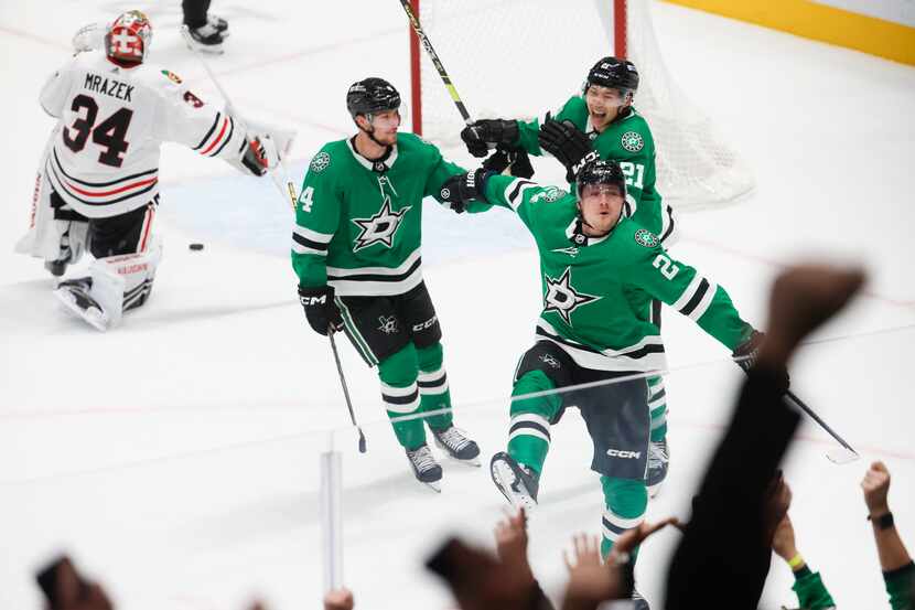 Crowd cheers as Dallas Stars center Roope Hintz (center) celebrates with Miro Heiskanen (4)...