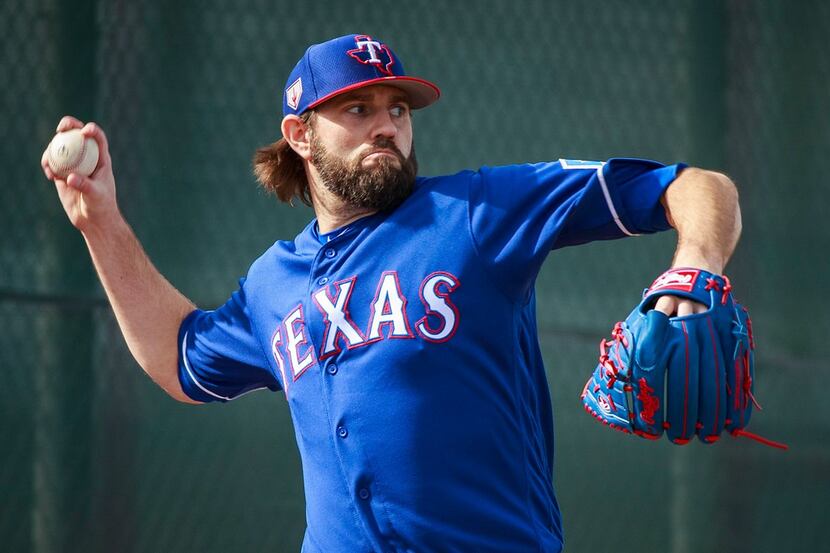 Texas Rangers pitcher Jason Hammel throws in the bullpen during a spring training workout at...