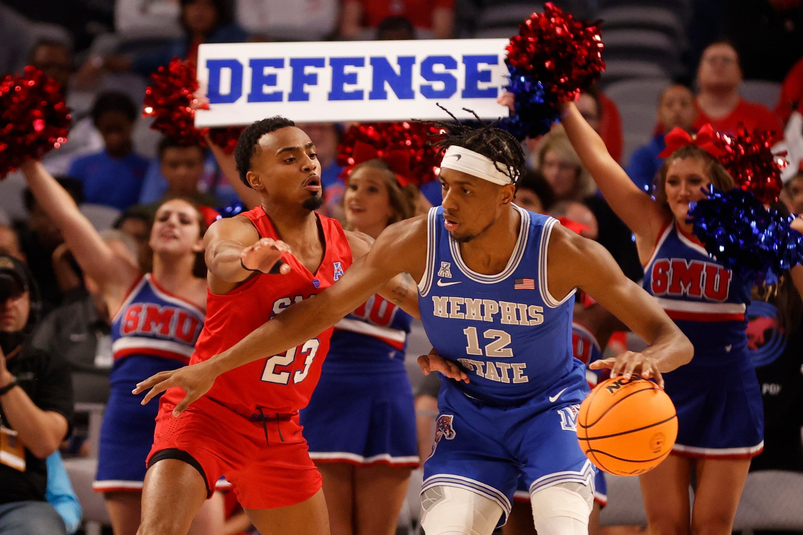 SMU guard Michael Weathers (23) defends against Memphis forward DeAndre Williams (12) during...