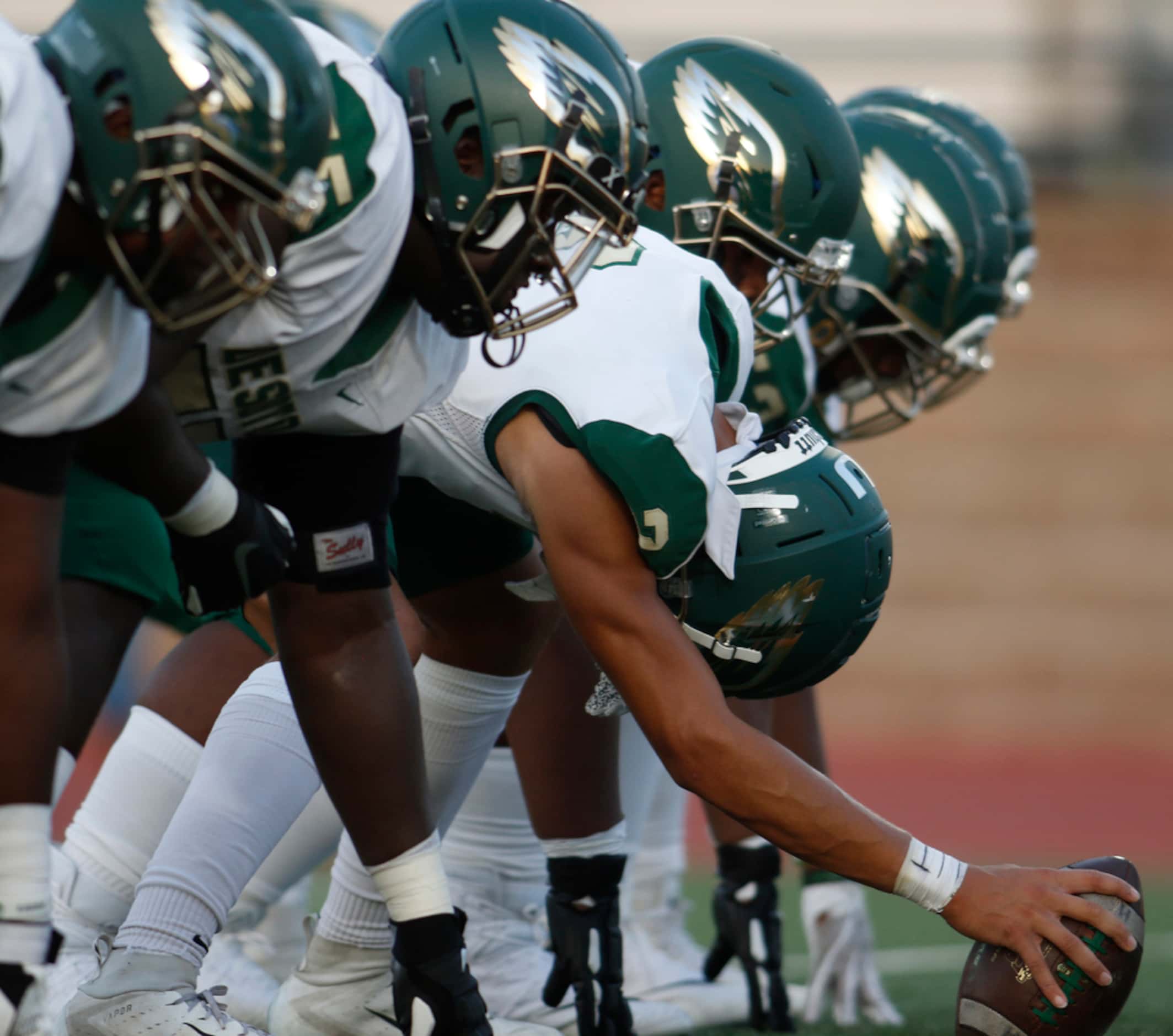 DeSoto Eagles special team members line up to snap an extra point following a first quarter...