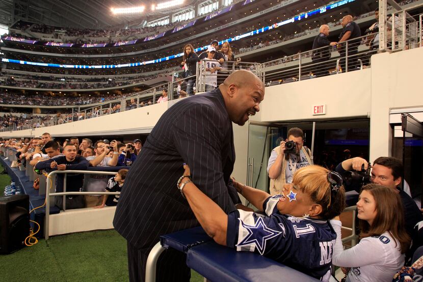 Dallas Cowboys Ring of Honor inductee Larry Allen hugs fan Carolyn Price prior to the start...