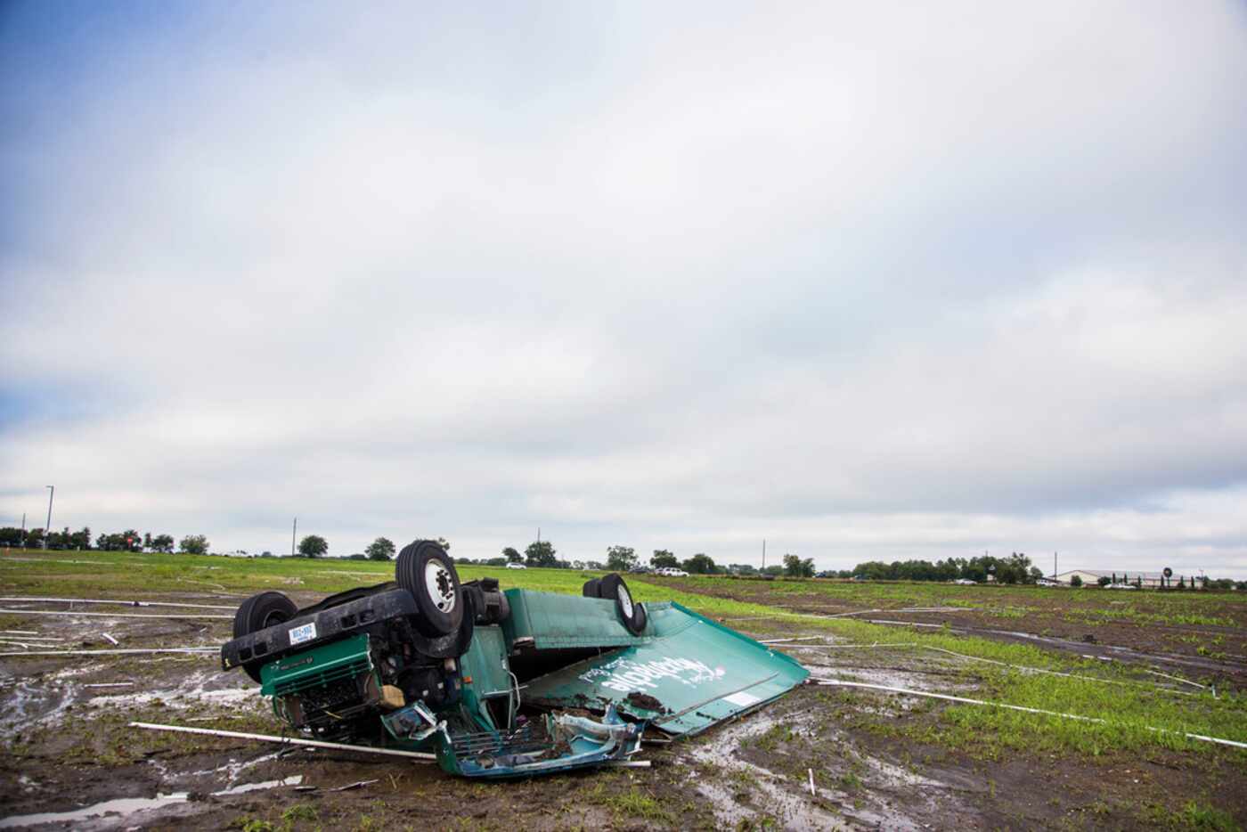 High winds rolled the "Spirit of Waxahachie Indian Band" bus into an empty field beside...