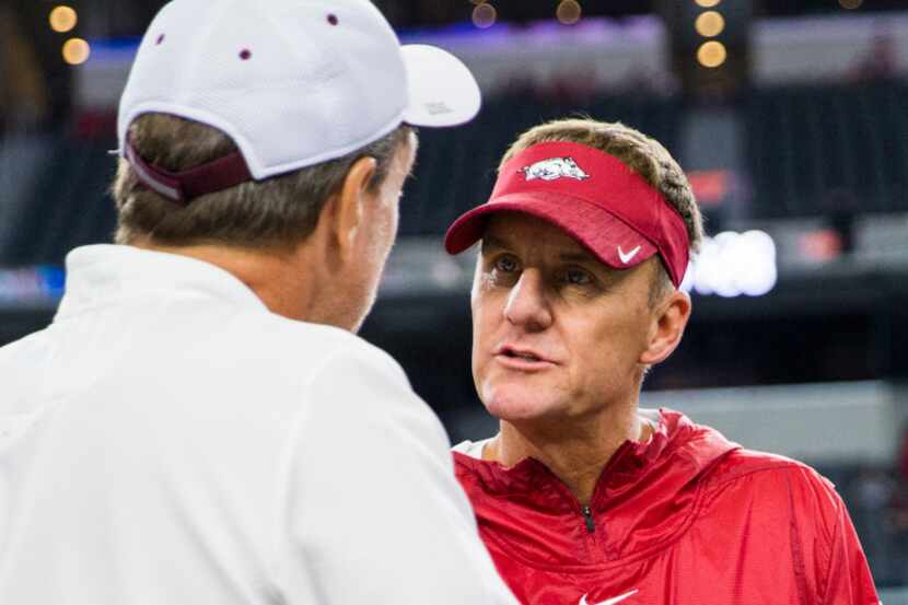 Arkansas Razorbacks head coach Chad Morris, right, greets Texas A&M Aggies head coach Jimbo...