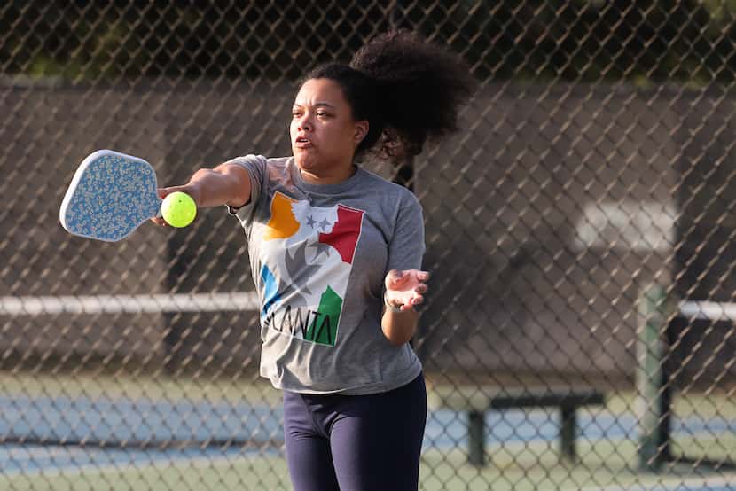 Maya Glaspie swings at the ball during a doubles game of pickleball.