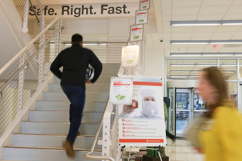 Employees walk inside Texas Instruments on Nov. 30 in Richardson. Texas Instruments makes...