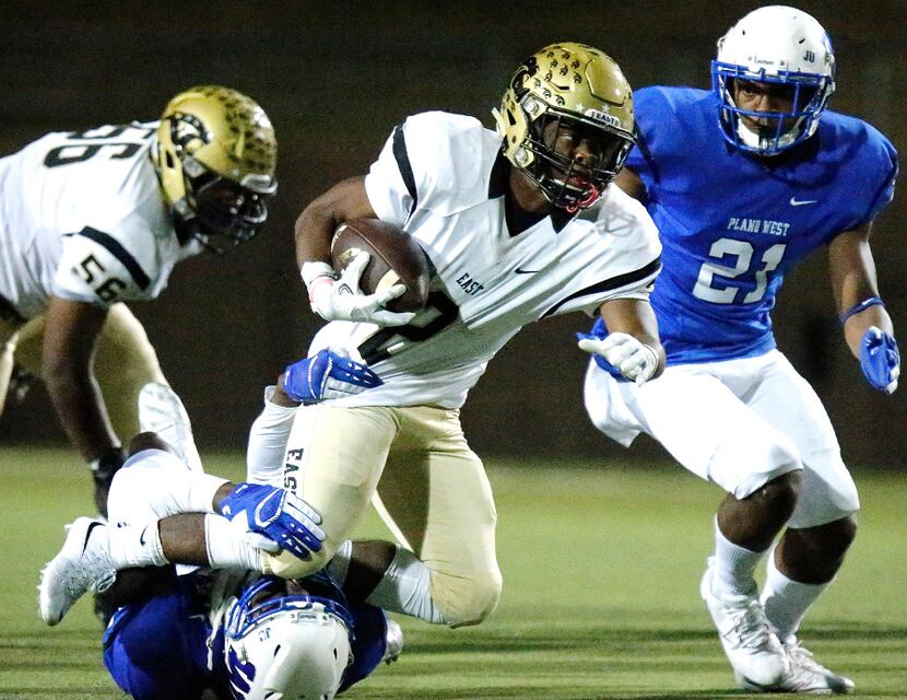FILE - Plano East running back Jonathan Meadors (2) is brought down by Plano West defensive...