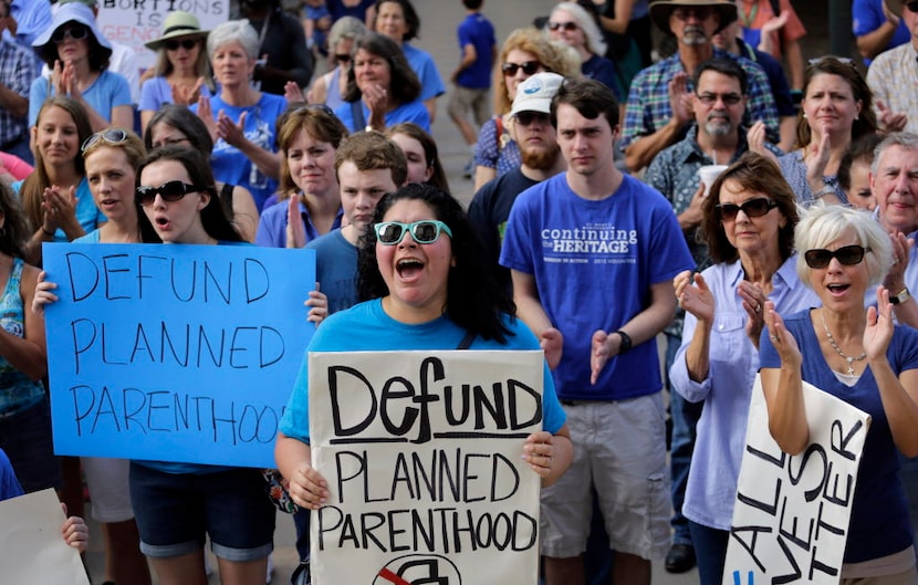 Erica Canaut (center) cheered as she and other anti-abortion activists rallied on the steps...