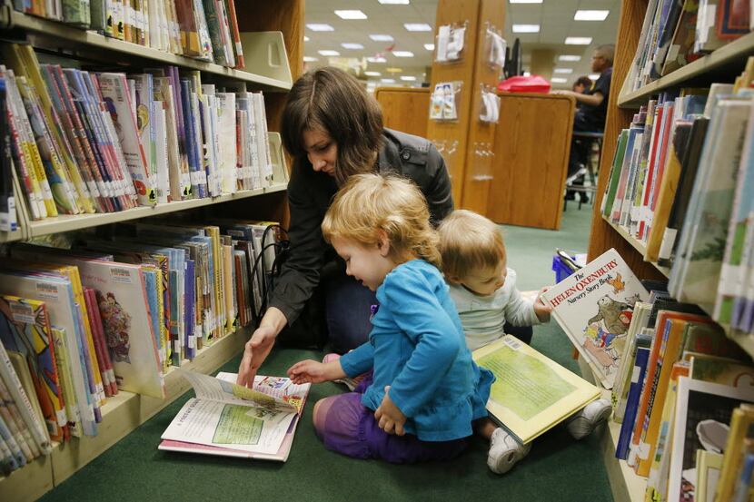Melodi Smith (top left), of Irving, Texas, reads a book with her daughter, Violet Smith...