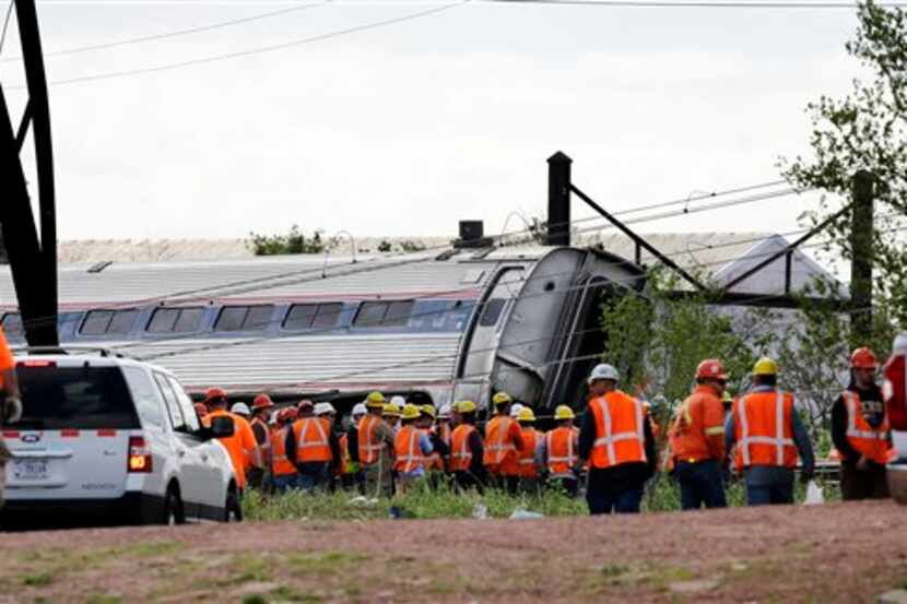  Emergency personnel gather near the scene of a deadly Amtrak derailment today in...