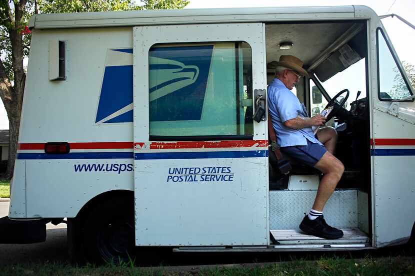 Larry Wilson sits in his delivery truck as he sorts mail in Lake Highlands. Dallas-Fort...