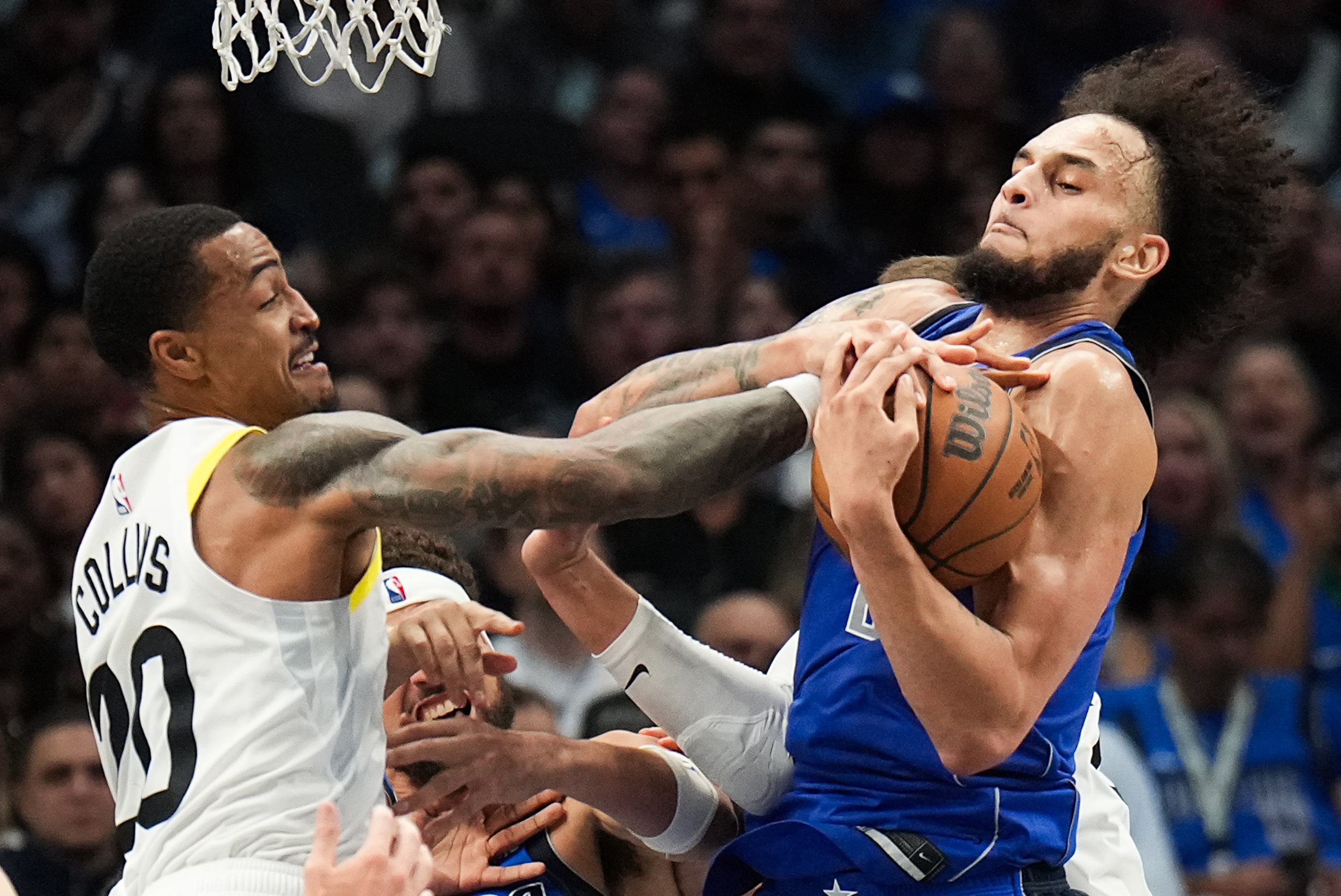 Dallas Mavericks center Dereck Lively II wrestles a rebound away from Utah Jazz forward John...