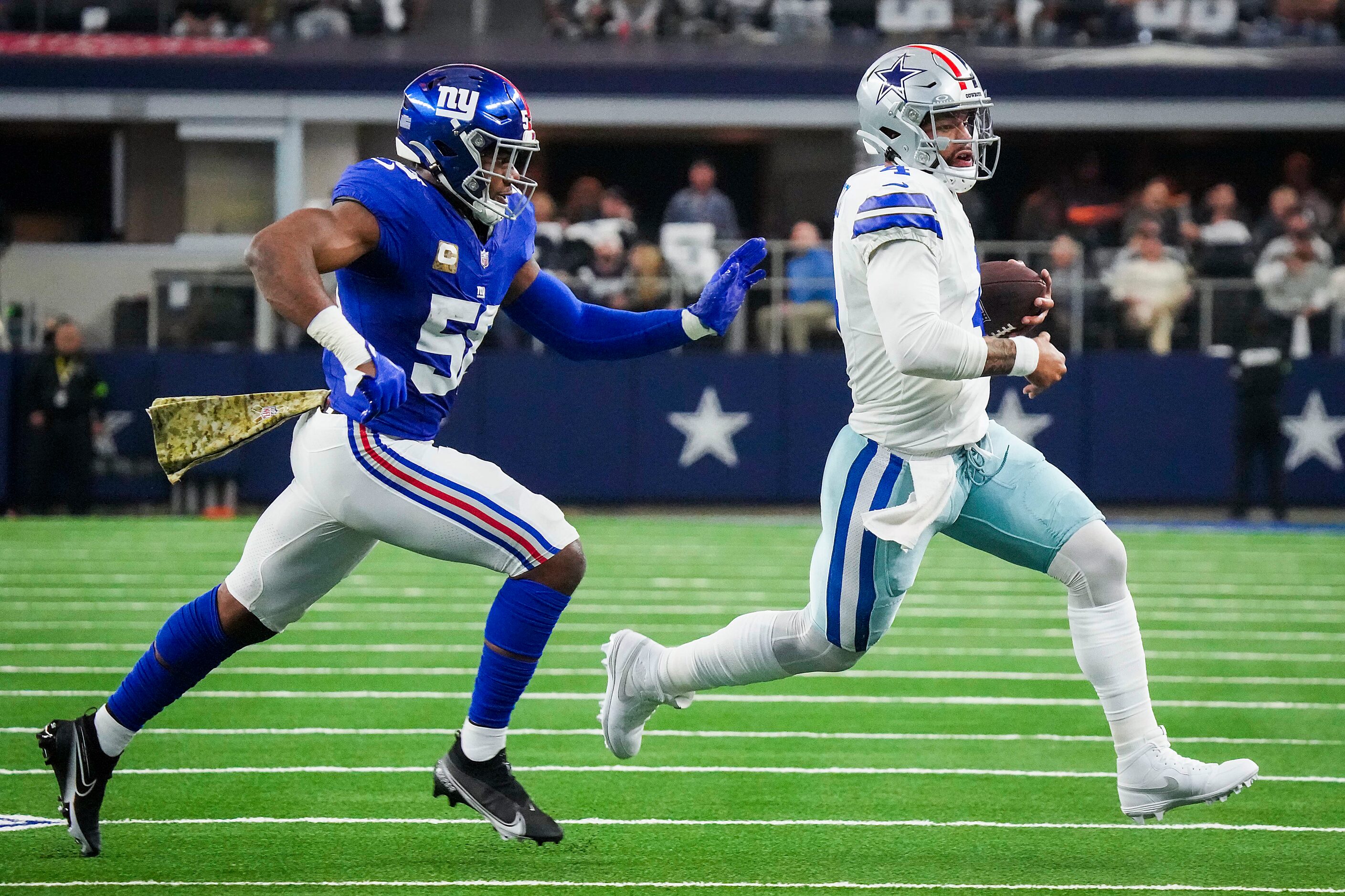 Dallas Cowboys quarterback Dak Prescott (4) scrambles past New York Giants linebacker Bobby...