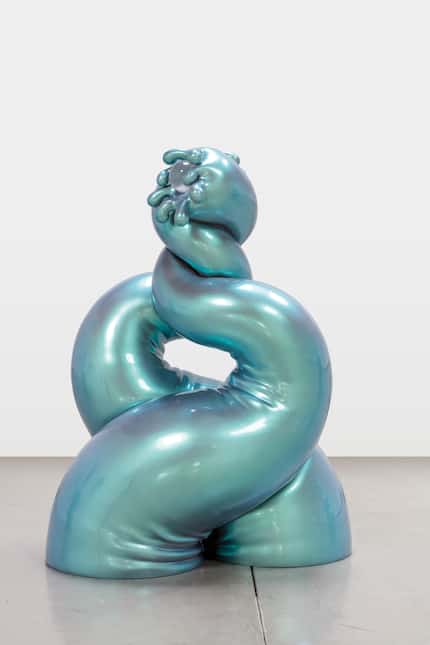 Whimsical sculpture of intertwining arms in a metallic teal color.