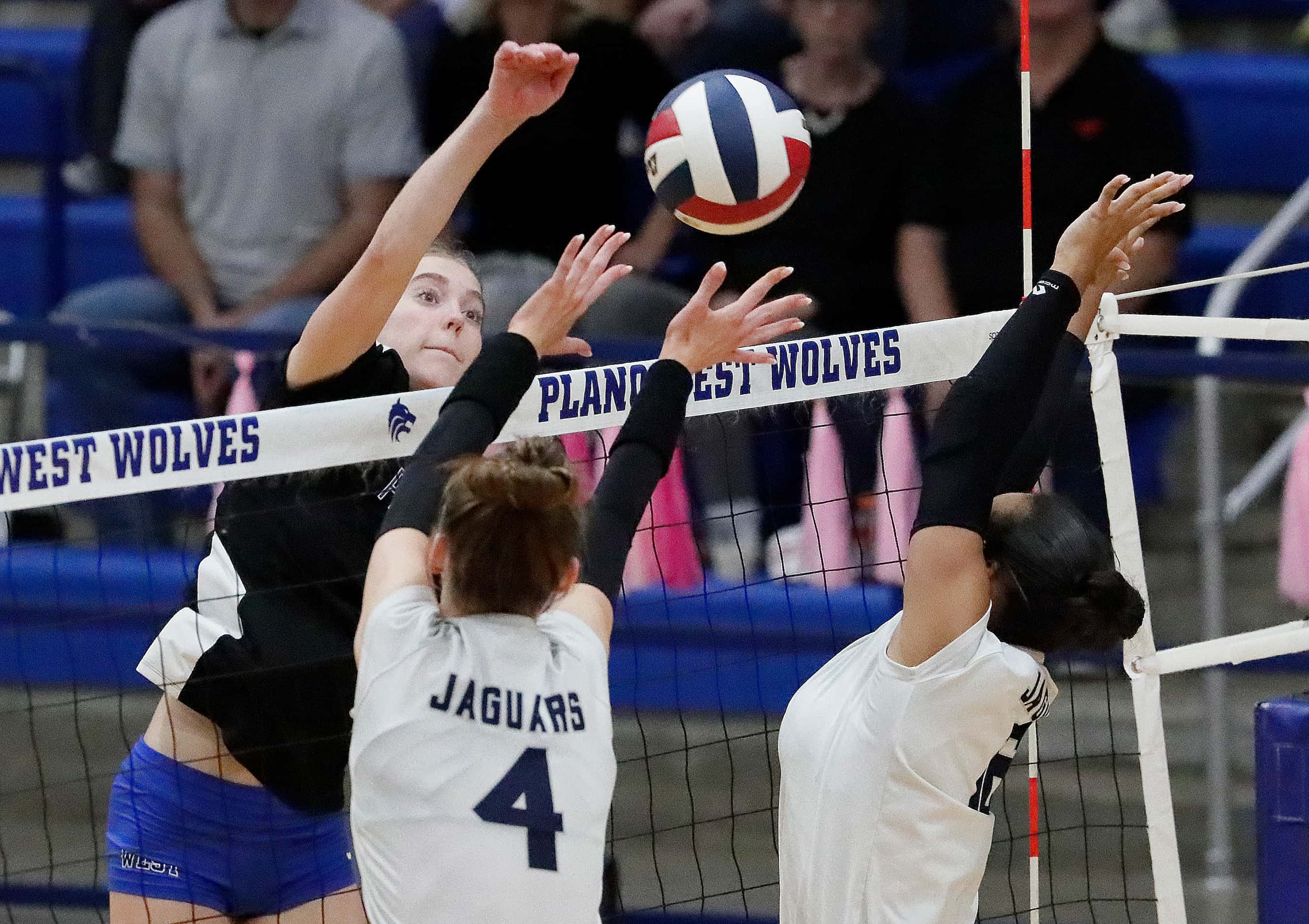 Plano West High School outside hitter Reese Poerner (8) gets a hit over Flower Mound High...